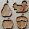Four piece wooden snack tray set featuring a squirrel, apple, acorn, and pear designs.